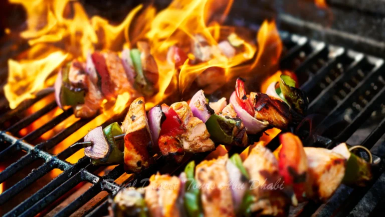 "A traditional BBQ setup glows under the starry sky during an evening desert safari in Abu Dhabi, where guests savor a flavorful desert safari and BBQ dinner in Abu Dhabi in the heart of the dunes