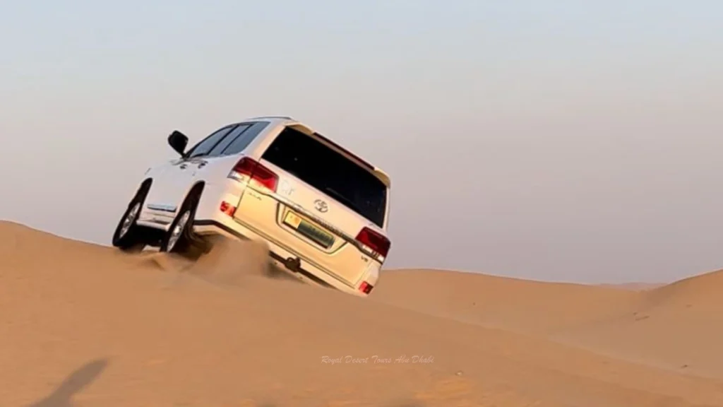 4x4 vehicle dune bashing during an Evening Desert Safari in Abu Dhabi with Desert Safari and BBQ Dinner experience